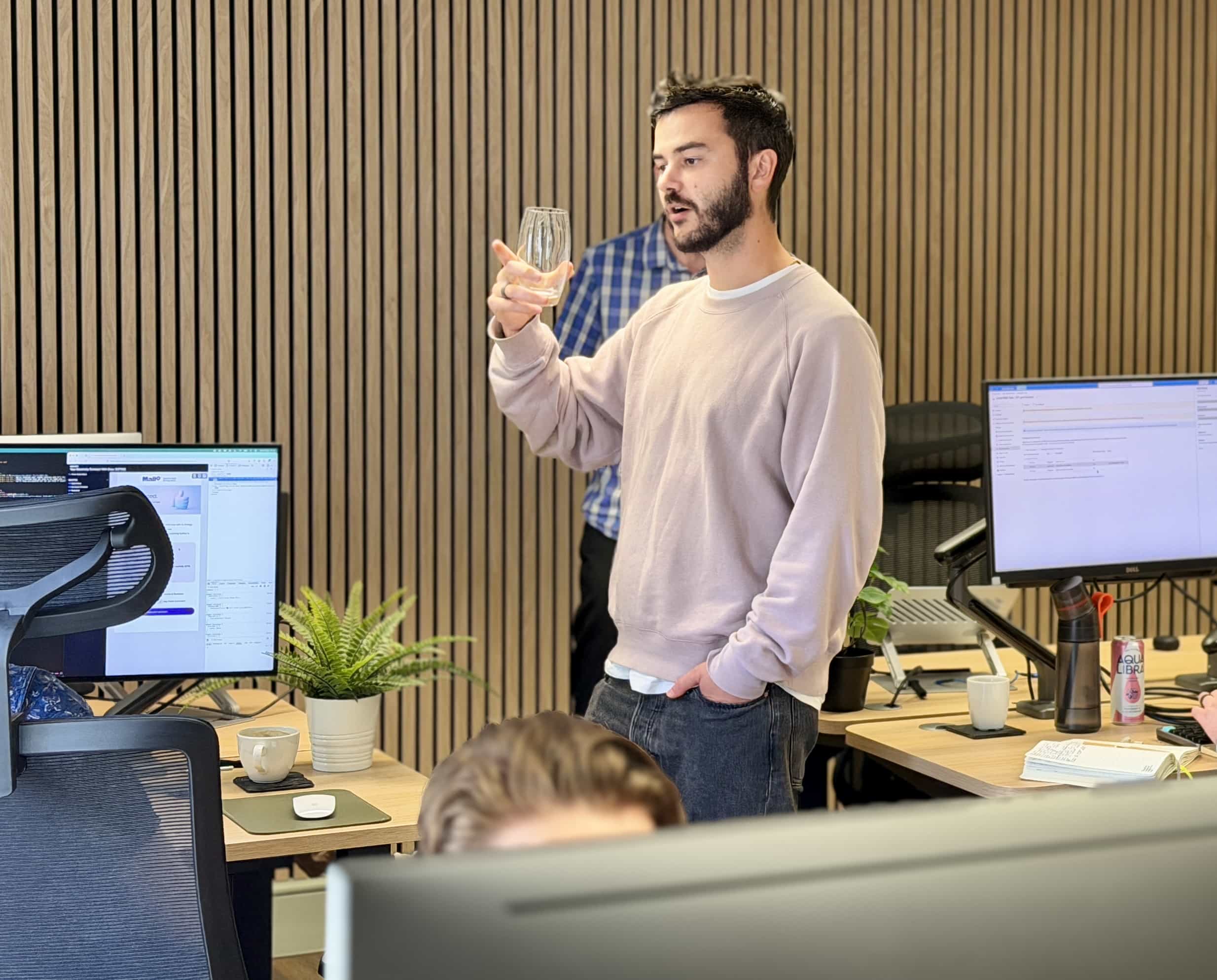 Charlie in the morphsites Project Management Team discusses an idea with a developer