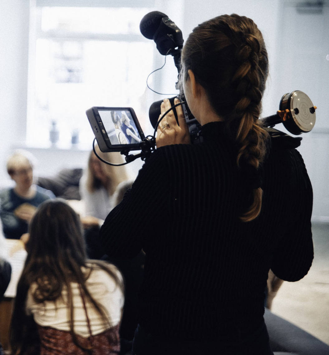 Person filming a group interview