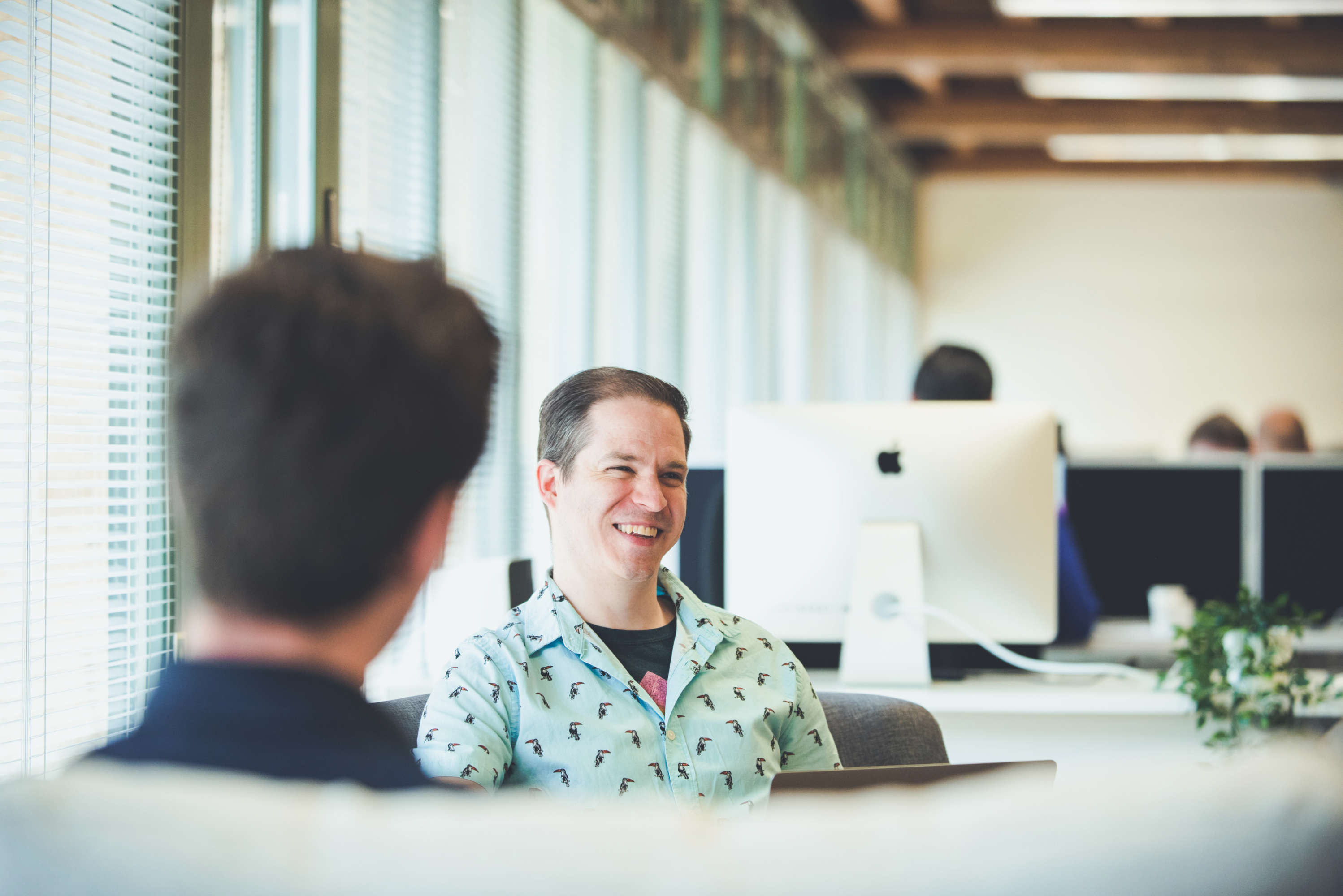 Senior designer smiling during a design review.