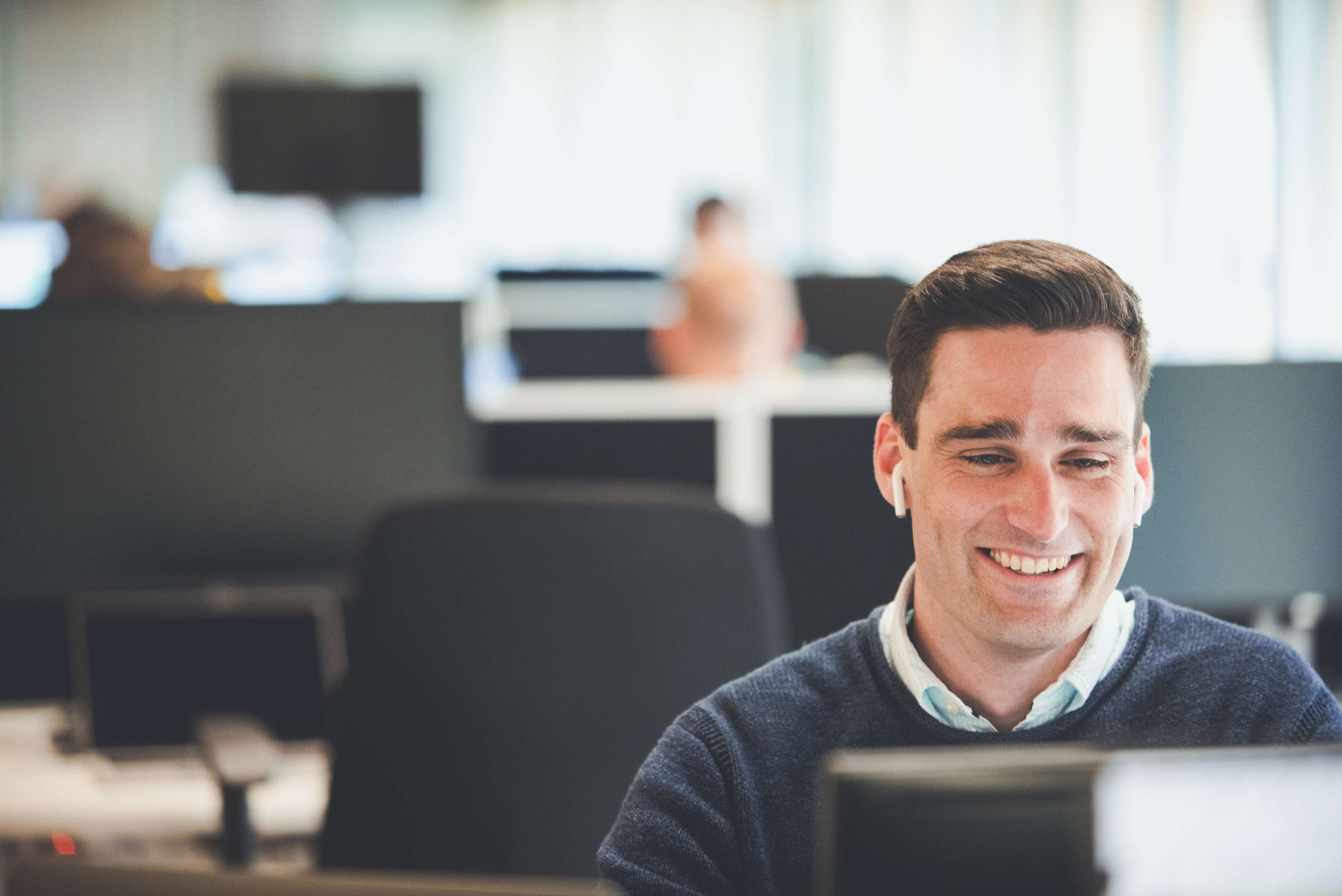 The senior client manager at their desk making a call with a customer.