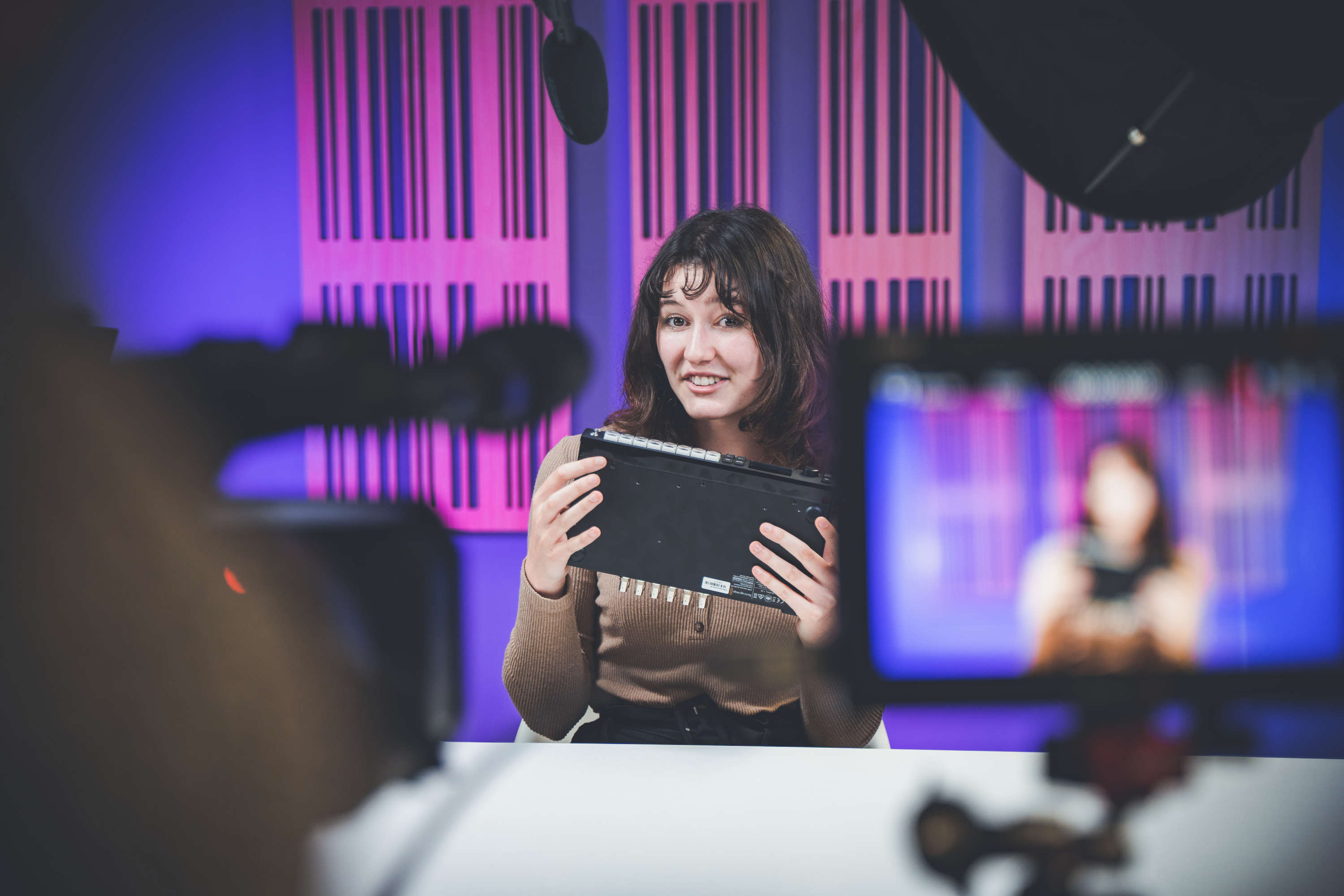 A presenter holds a product whilst filming a video review.